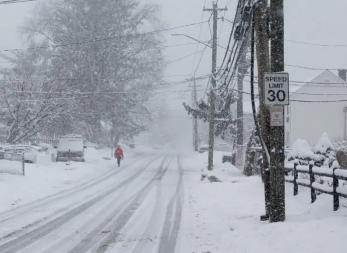 Person is walking in snow storm day on North Taylor Avein Norwalk NORWALK^ CT^ USA -FEBRUARY 7^ 2021