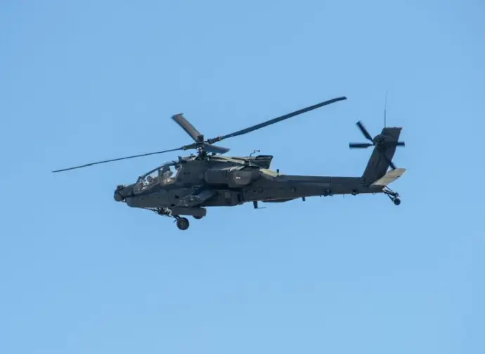 Army Apache AH-64 Helicopter during the Dragoon Ride Exercise on March 22^ 2015 in Vilnius^ Lithuania. The Boeing AH-64 Apache is a four-blade^ twin-turboshaft attack helicopter. VILNIUS - MAR 22