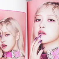 Fan hands holding BlackPink BORN PINK 2nd Album photobook with Rose on grey. Pink music CD in player. South Korean girl group BlackPink. Space for text. Gatineau^ QC Canada - November 10 2022.