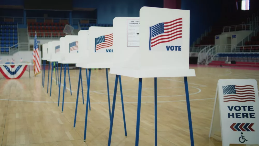 Voting booths with American flag logo at polling station. National Election Day in the United States of America.