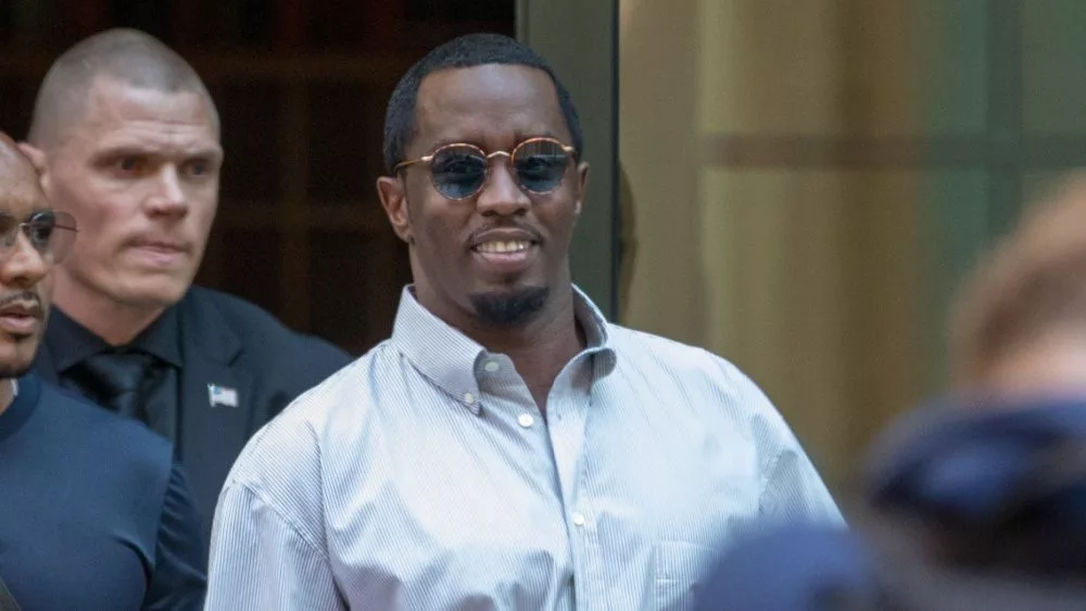 Sean “Diddy” Combs exiting the Crosby Street Hotel and heading to a waiting line of black SUV's surrounded by paparazzi and flanked by security. Lower Manhattan NYC^ New York / USA - July 24^ 2019