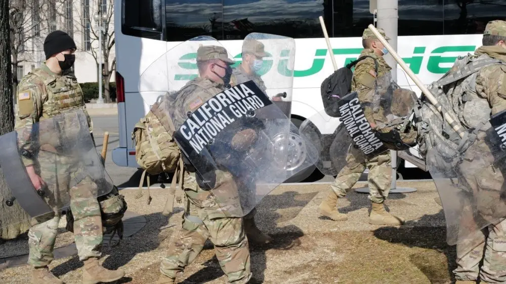 California National Guard troops prepare to board a bus for their return home after completing their assignment in Washington during the inauguration. Washington^ DC ā January 22^ 2021