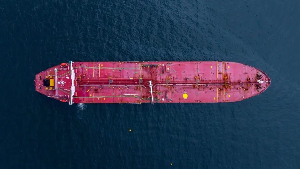 Aerial view crude oil tanker ship at sea^ Red crude oil tanker ship top view^ Logistic and maritime transpoprtation of petroleum^ Modern offshore terminal loading tanker ship.