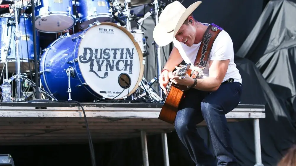 Dustin Lynch performs during the 'Kick The Dust Up' Tour at Vanderbilt Stadium on July 11^ 2015 in Nashville^ Tennessee.