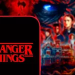 Computer keyboard with the Iphone 11 pro with the Stranger Things logo.