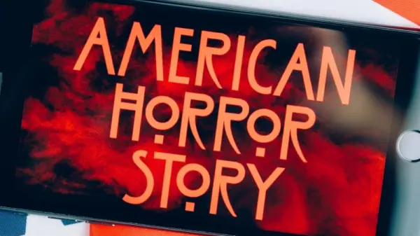 Screensaver with the 'American horror story' logo on a smartphone on toned background