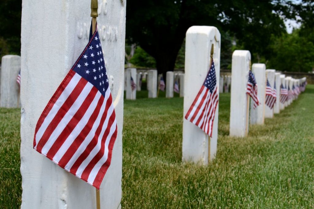 rows-of-grave-stones-in-a-national-cemetery-decorated-with-american-flags-for-memorial-day-1024x683-1