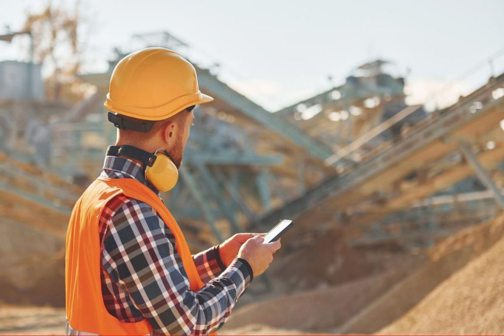 with-yellow-headphones-on-neck-construction-worker-in-uniform-is-on-the-quarry-1024x683-1