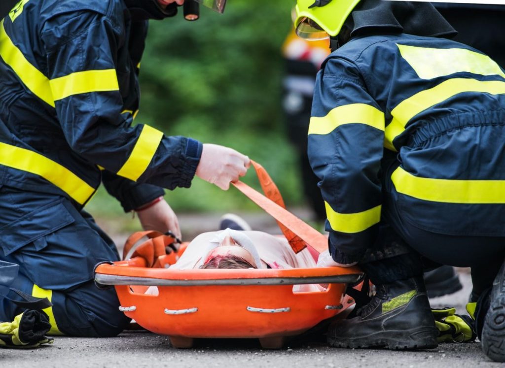 firefighters-putting-an-injured-woman-into-a-plastic-stretcher-after-a-car-accident-1024x747-1