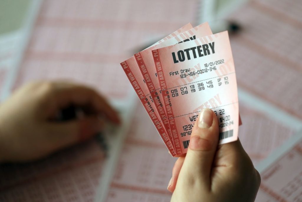 filling-out-a-lottery-ticket-a-young-woman-holds-the-lottery-ticket-with-complete-row-of-numbers-1024x683-1