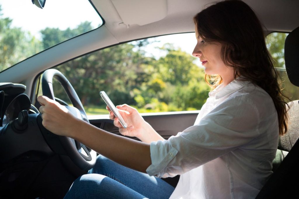 woman-using-mobile-phone-while-driving-a-car-1024x683457388-1