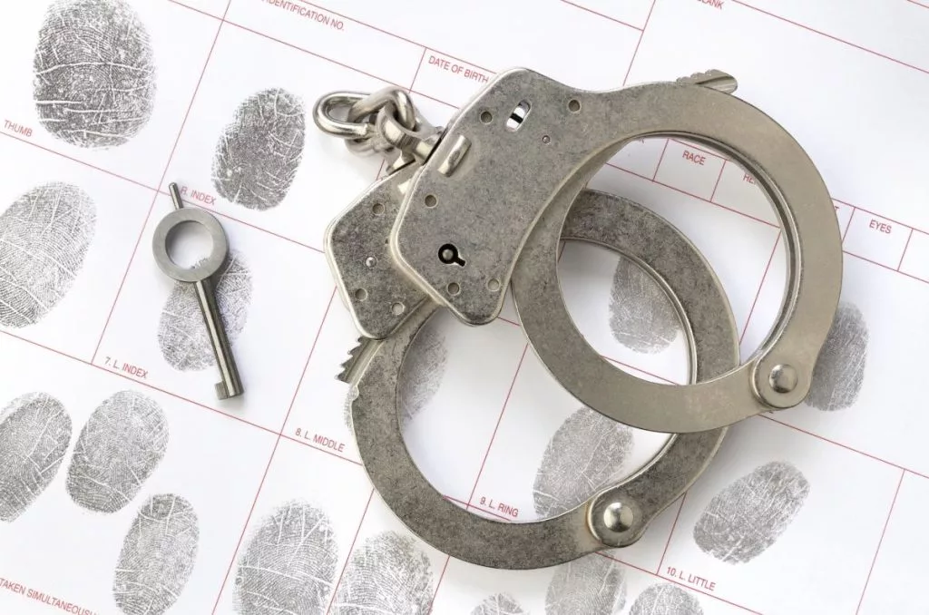 handcuffs-on-fingerprint-sheet-1024x67876225-1