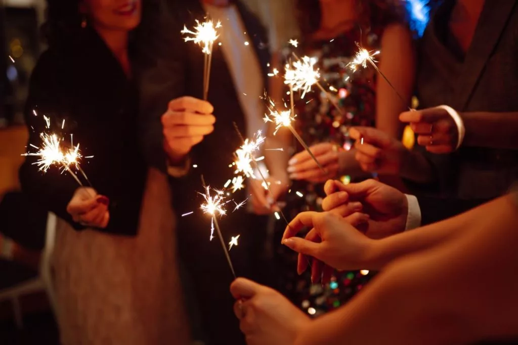 sparkling-sparklers-in-hands-playing-firework-to-celebrate-winter-holidays-with-friends-at-party-1024x683311387-1