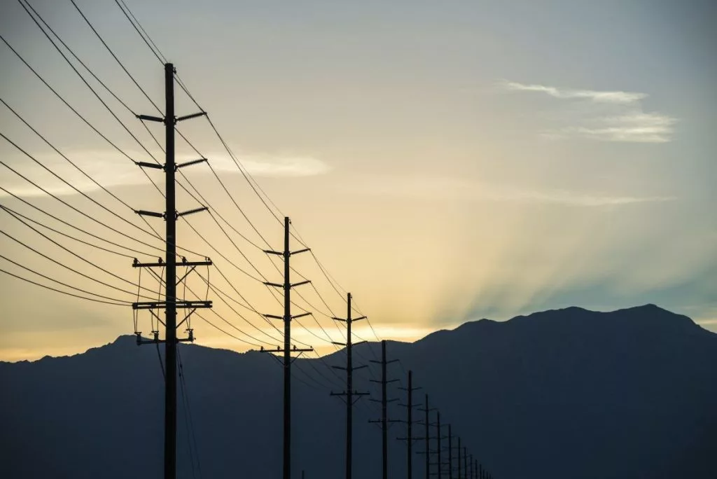 a-row-of-poles-and-communication-or-power-lines-at-sunset-1024x684269960-1