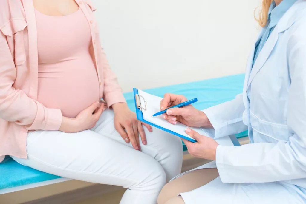 cropped-shot-of-obstetrician-gynecologist-consulting-pregnant-woman-at-clinic-1024x68477941-1