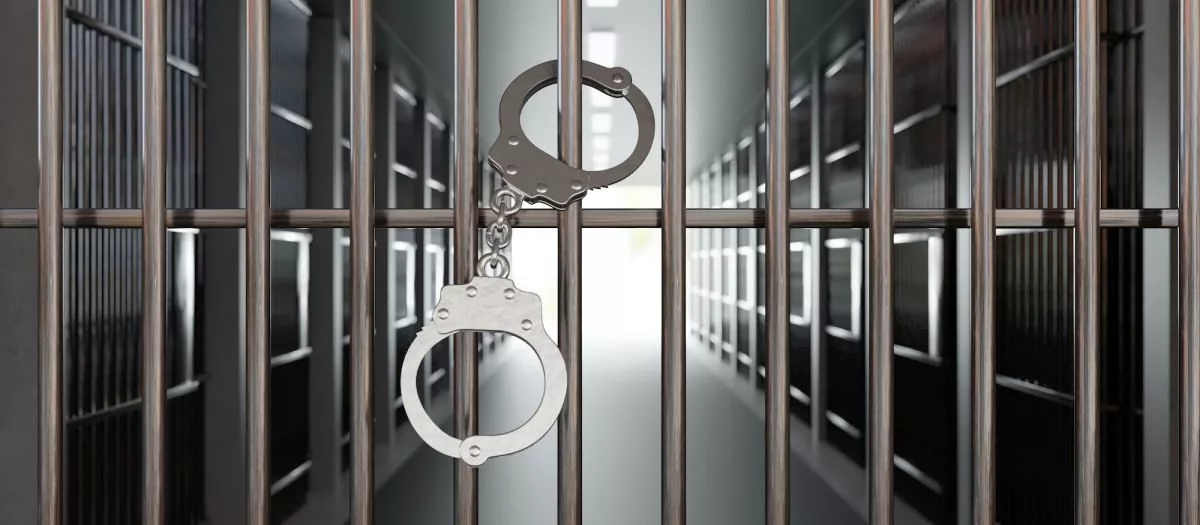 handcuffs-on-jail-cell-closed-metal-bar-door-prison-building-corridor-background-3d-render193606