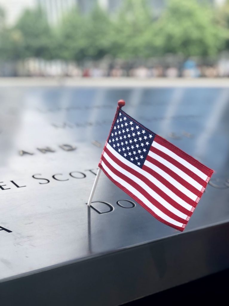 american-flag-on-a-name-on-the-911-world-trade-center-memorial-767x1024-1