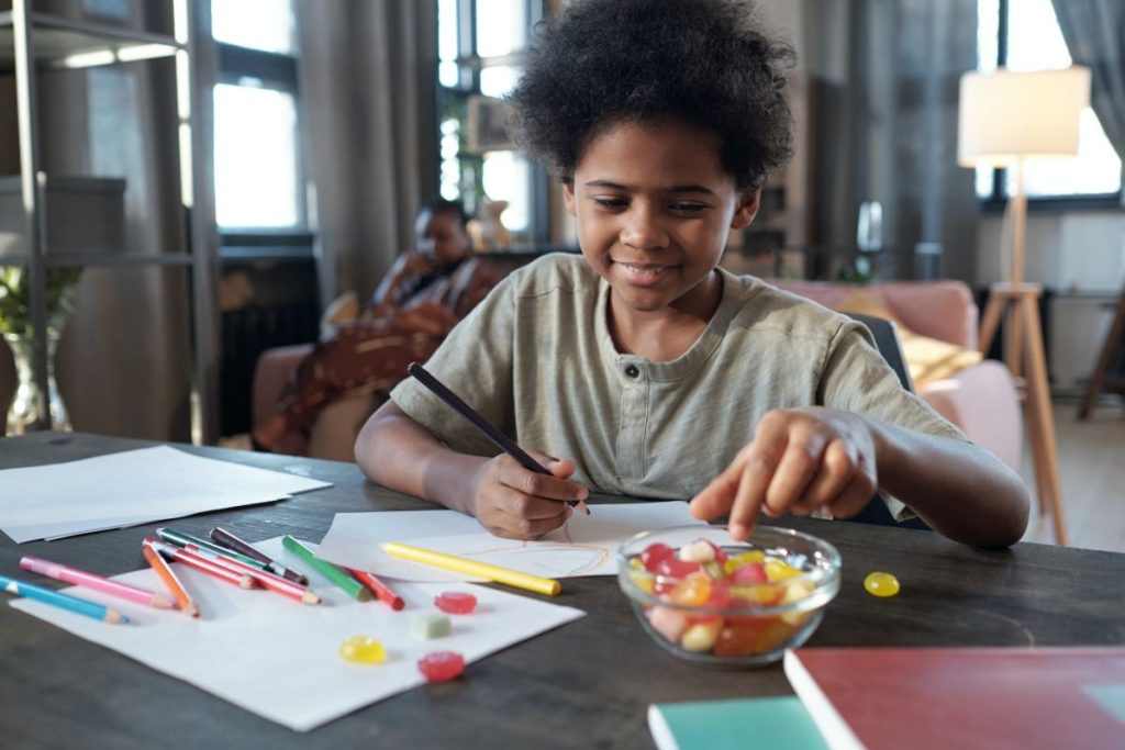 happy-african-schoolboy-taking-candy-out-of-bowl-1024x683-1