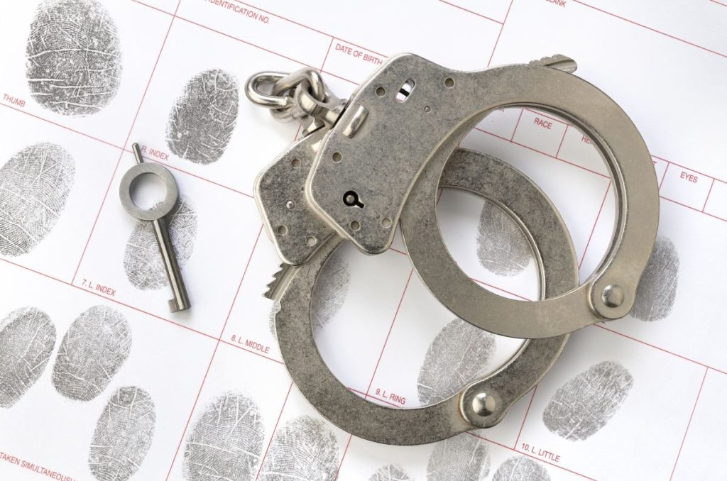 handcuffs-on-fingerprint-sheet-1024x678-2101541