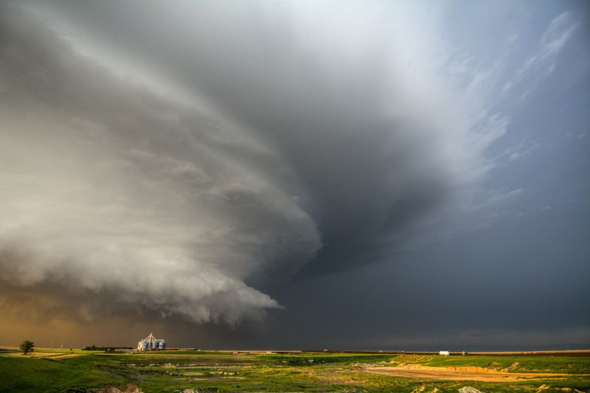 a-tornado-producing-supercell-thunderstorm-spinning-over-ranch-land-at-sunset-near-leoti-kansas542117
