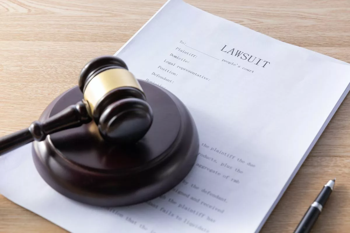 high-angle-shot-of-a-gavel-and-lawsuit-papers-on-a-wooden-surface227823