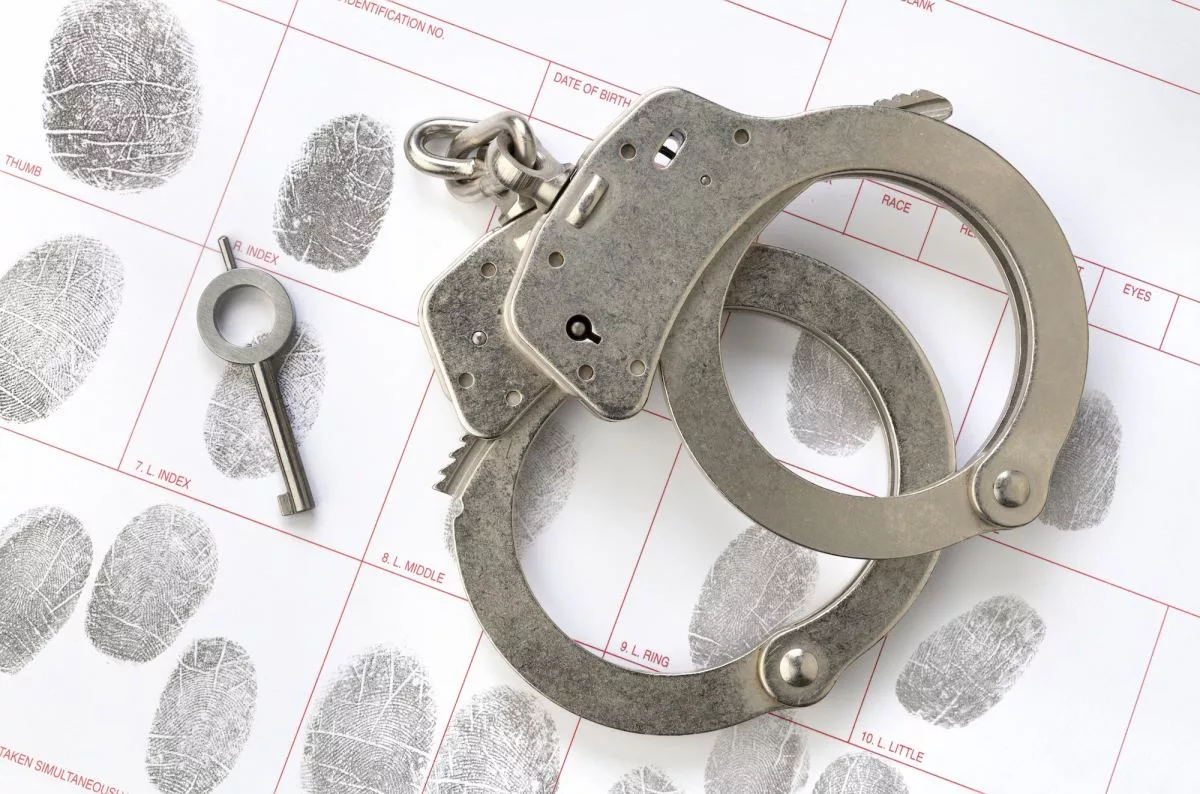 handcuffs-on-fingerprint-sheet573237