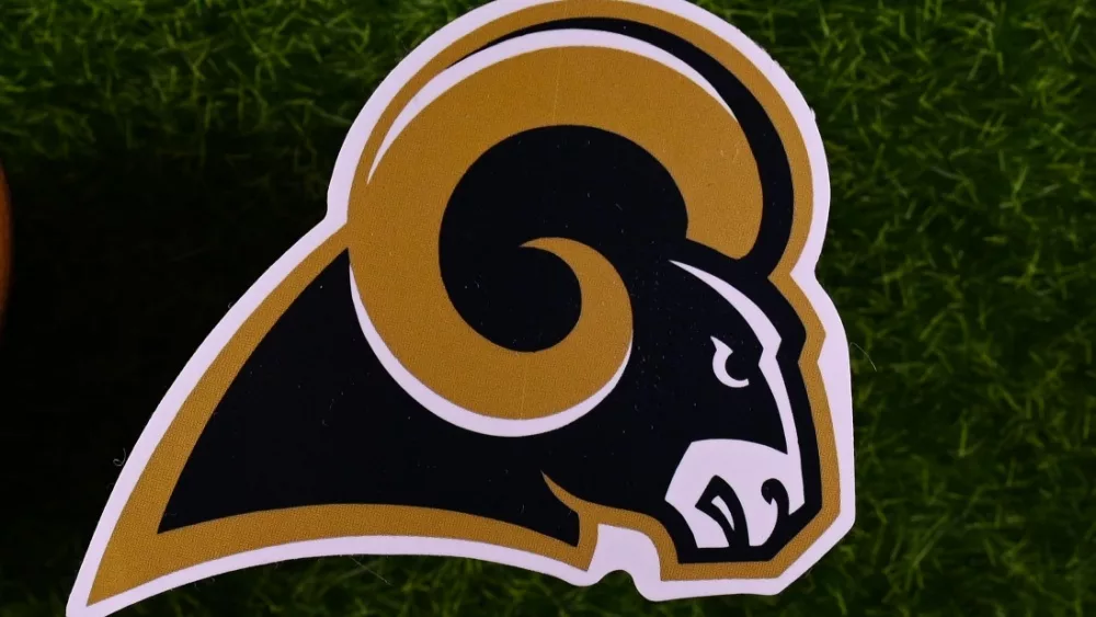 The logo of the Los Angeles Rams football club on the green lawn of the stadium.