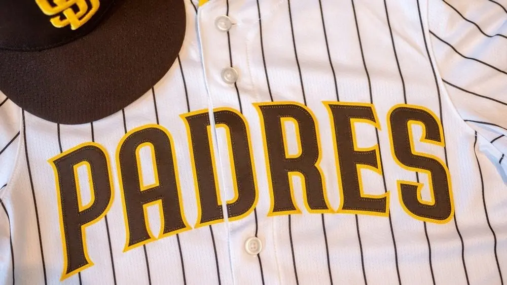 San Diego Padres baseball hat and team jersey.