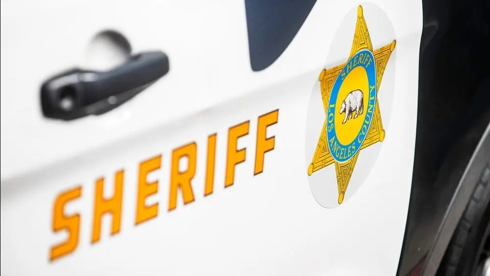 Close-up of a Los Angeles County Sheriff's Department badge and lettering on the side of a patrol vehicle. 2024-11-15 Los Angeles USA