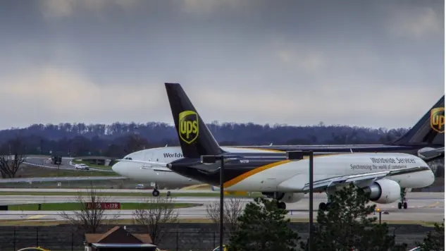 Louisville^ KY—March 6^ 2018 air cargo planes taxi to end of runway prior to take off