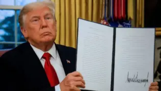 President Donald Trump signs executive orders in the Oval Office of the White House on January 20^ 2025 in Washington^ DC.