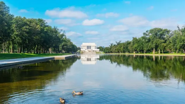 World famous Lincoln Memorial reflected in the water under a cloudy sky. Washington D.C.^ USA