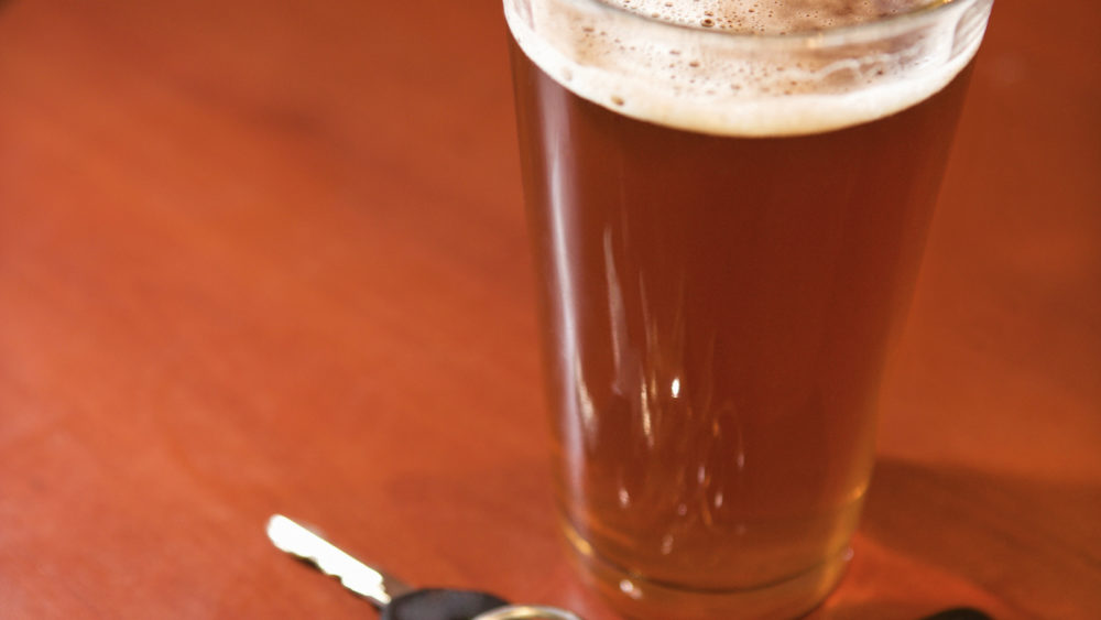 glass-of-beer-and-keys-on-bar-table