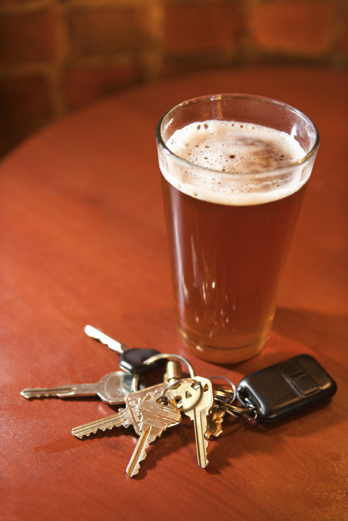 glass-of-beer-and-keys-on-bar-table