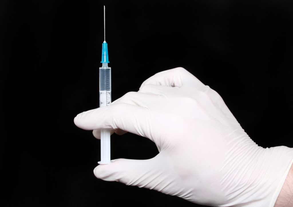 syringe-in-medical-gloves-hand-injection