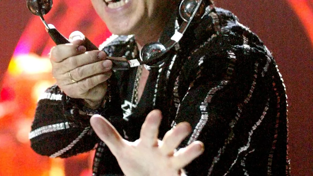 scorpions-singer-klaus-meine-is-seen-through-a-tambourine-as-he-performs-during-the-first-stop-of