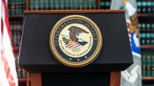 Seal of Justice Department seen during press conference at US Attorney Office library