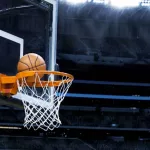 basketball going into hoop at arena (NBA)