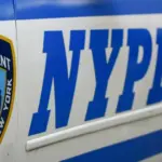 Side door closeup of Nypd police patrol car are patrolling parked near the curb. New York november 2020