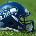 NFL Seattle Seahawks replica helmet on artificial grass playing turf ^ product shot