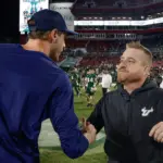 NCAA Football: Florida Atlantic at South Florida: Oct 18, 2025; Tampa, Florida, USA;  South Florida Bulls head coach Alex Golesh (right) shakes the hand of Florida Atlantic Owls head coach Zach Kittley after the game at Raymond James Stadium. Mandatory Credit: Reinhold Matay-Imagn Images