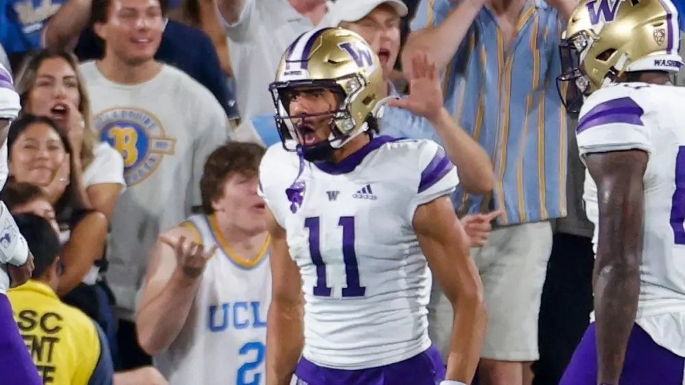 Washington's Jalen McMillan (11) celebrates with teammates after scoring a touchdown against the UCLA during an NCAA college football game Friday^ Sept. 30^ 2022^ in Pasadena^ Calif.