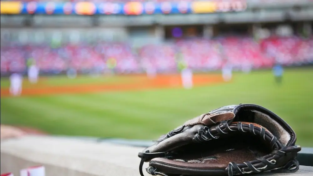 Baseball glove on the wall with a major league stadium in the background