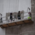 Workers begin painting the Producers Coop Elevator on May 2, 2022. (Ryan Crowe/FCR)