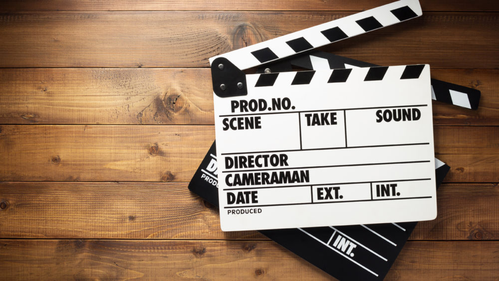 movie-clapper-board-at-wooden-background