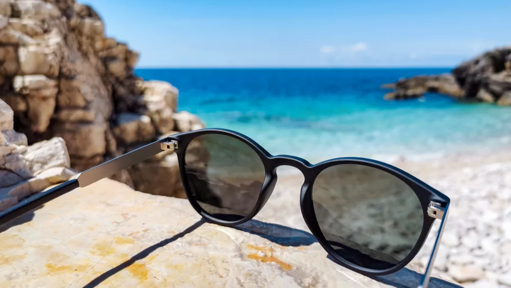 close-up-image-of-sunglasses-on-beach-in-summer-2022-11-14-17-35-26-utc