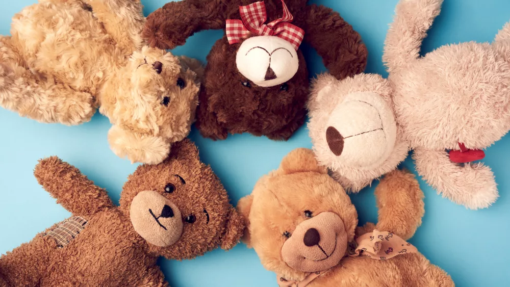 various-teddy-bears-lie-on-a-blue-background-head-to-head-and-lo