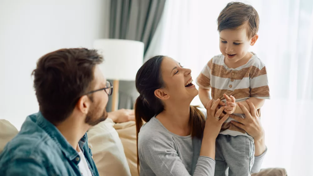 happy-little-boy-having-fun-with-his-parents-at-home