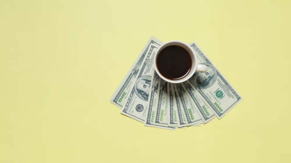 coffee-with-dollar-money-on-yellow-background-2023-11-27-05-20-49-utc
