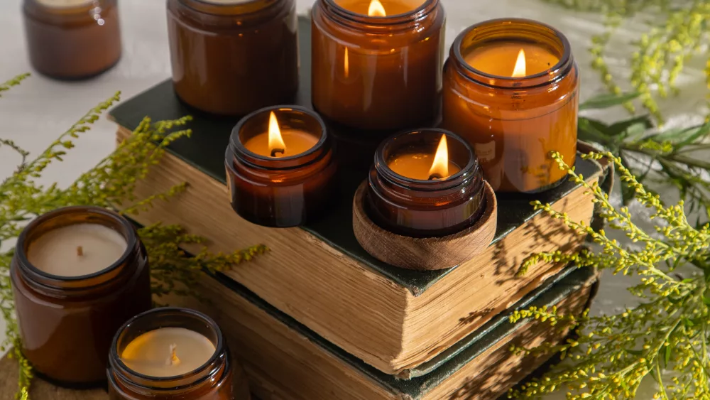 a-set-of-different-aroma-candles-in-brown-glass-jars-scented-handmade-candle-soy-candles-are-burning-in-a-jar-aromatherapy-and-relax-in-spa-and-home-still-life-fire-in-brown-jar